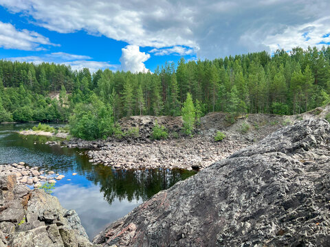 A vast expanse of water beautifully encircled by trees and rocks