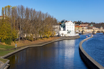 Autumn sunny morning over the navigation channel on the Vltava River in Prague and a view of the...
