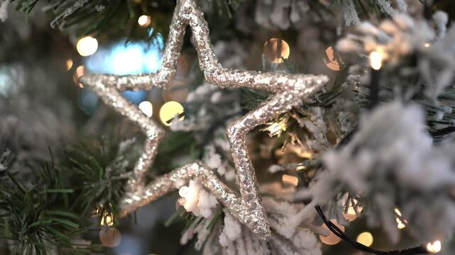 tmas tree toy large gold star weighs on the tree with bokeh. High quality 4k footage