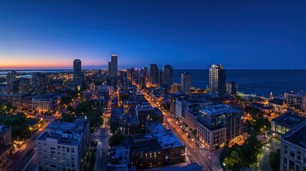 Fototapeta premium Cityscape at dawn, overlooking lakefront buildings and streets.