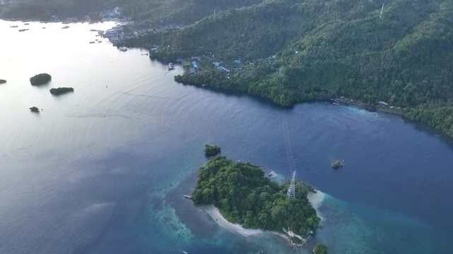 Calm water flows through Lembeh Strait, separating North Sulawesi from Lembeh Island. This tropical area is home to a plethora of marine biodiversity and is popular among divers.