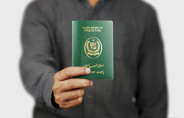 Brown Man Holding Pakistani Passport with White Background