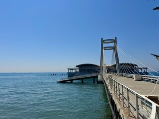 Obraz premium view of a pier in Durres in Albania with a building in the background on the Adriatic sea on a sunny summer day 