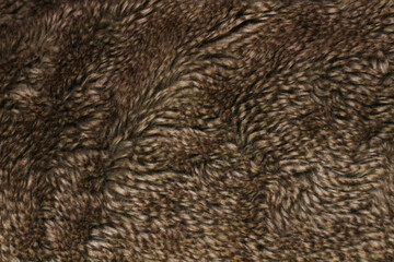 Close-up of a textured faux fur fabric in shades of brown.