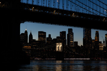 View towards Brooklyn Bridge from under the Manhattan Bridge at dusk