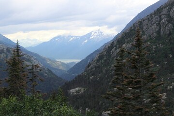 Obraz premium Deep valley and clouds hanging over the top of mountains in Southern Alaska