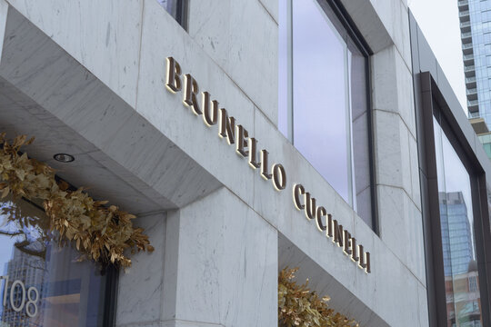 stone marble exterior facade and sign of Brunello Cucinelli, a clothing boutique, located at 108 Yorkville Avenue in Toronto, Canada