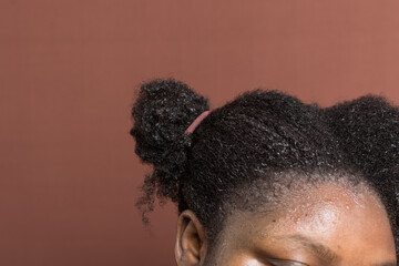 Black afro curly hair with shrinkage, Wet Type 4c hair being detangled