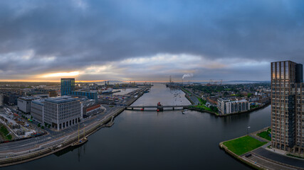 The image showcases a bustling waterfront scene at Dublin Port, featuring a modern bridge spanning across the harbour in Dublin Ireland