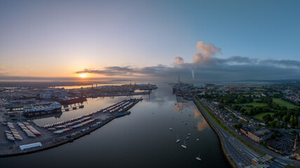 The image showcases a bustling waterfront scene at Dublin Port, featuring a modern bridge spanning across the harbour in Dublin Ireland