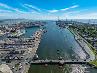 The image showcases a bustling waterfront scene at Dublin Port, featuring a modern bridge spanning across the harbour in Dublin Ireland