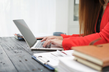 A cheerful businesswoman works at her office desk as a legal consultant, handling online civil...
