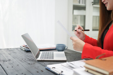 A cheerful businesswoman works at her office desk as a legal consultant, handling online civil...