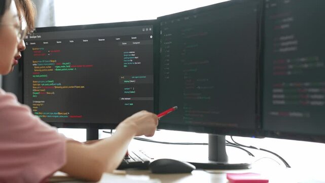 Back end software developer engineer for computer programming working together on debugging writing computing code, solving complex algorithms display on monitor in office. Burgeoning
