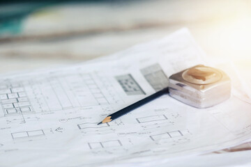 There is a pencil and a measuring tape on the paper.