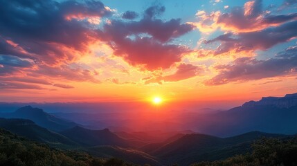 Fototapeta premium Majestic mountain sunrise with vibrant clouds and layered peaks in scenic landscape