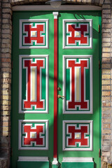 Obraz premium Decorative wooden doors with millwork painted in red and yellow