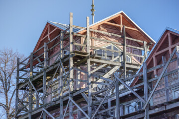 
a building under construction around which wooden racks are installed