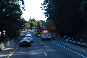 Emergency road work causing traffic slowdown on a busy highway in the early evening