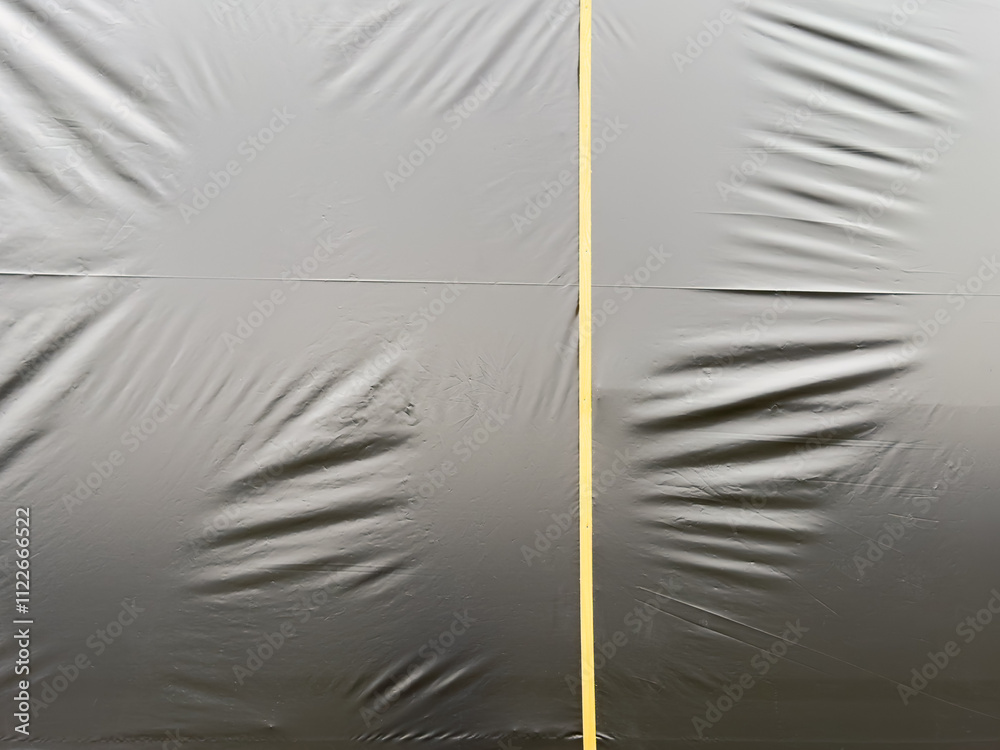 Canvas Prints a black plastic sheet with a yellow line running through it