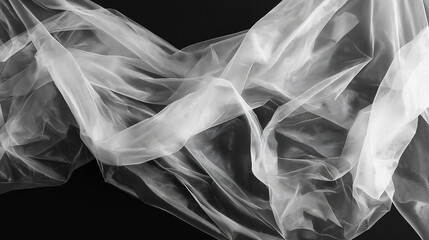 Fototapeta premium Elegant white sheer fabric draped on black background. Concept of luxury, wedding, and fashion.