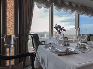 Formal and elegant ocean view Art Deco dining room restaurant onboard luxury cruiseship or cruise...