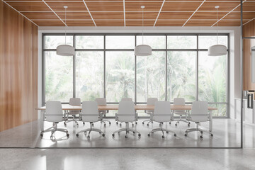 Spacious and modern conference room with white chairs and wooden table, featuring large windows...