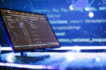 Abstract software development concept with code and laptop on blurred background representing...