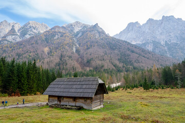 Drone aerial of wooden mountain hut overlooking valley julian alps, slovenia.