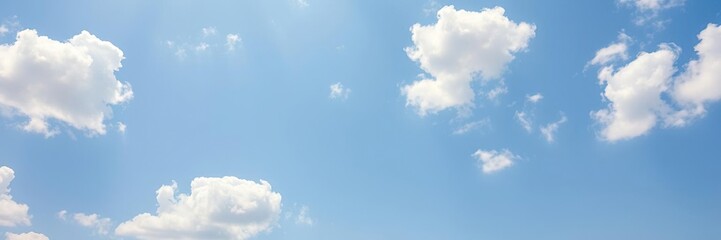 Fototapeta premium White and fluffy clouds dot a bright blue sky with a subtle gradient from light to dark, outdoor scenery, light airy texture, clear blue