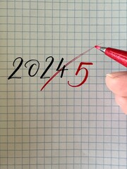 New Year 2025 handwritten numbers on paper, end of the old year 2024