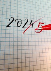 New Year 2025 handwritten numbers on paper , end of the old year 2024