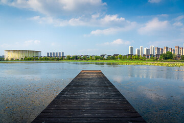 Urban Lakefront with Wooden Dock and Skyline