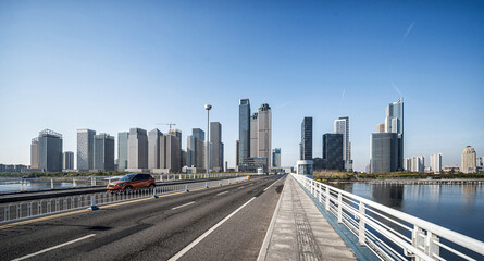 Naklejka premium Modern City Skyline and Bridge on a Sunny Day