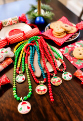 A vibrant Christmas setting featuring colorful beaded necklaces, cookies, and holiday crackers. Perfect for adding festive cheer to your holiday celebrations and gatherings.

