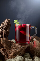 Hot drink with cranberries, lime, and rosemary.