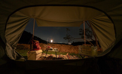 Camping Tent with at night time with mountain view. Outdoor activity and lifestyle.