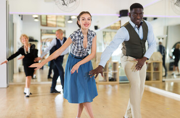 Fototapeta premium Woman and man dancing swing in studio