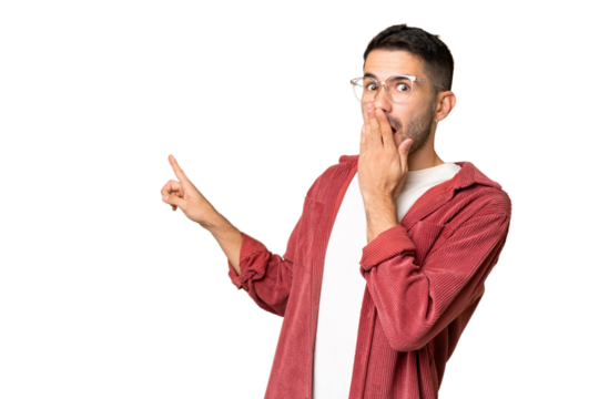 Young handsome caucasian man over isolated chroma key background with surprise expression while pointing side