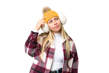 Young pretty blonde woman wearing winter muffs over isolated chroma key background having doubts...