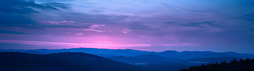 Obraz premium Majestic mountain range at twilight with vibrant sunset colors.