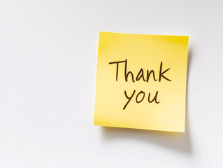 A single yellow sticky note with the words "Thank you," offering a simple, thoughtful gesture.

