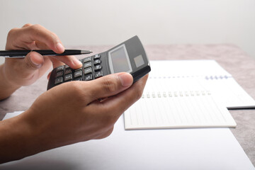 Man using calculator to count income and outcome