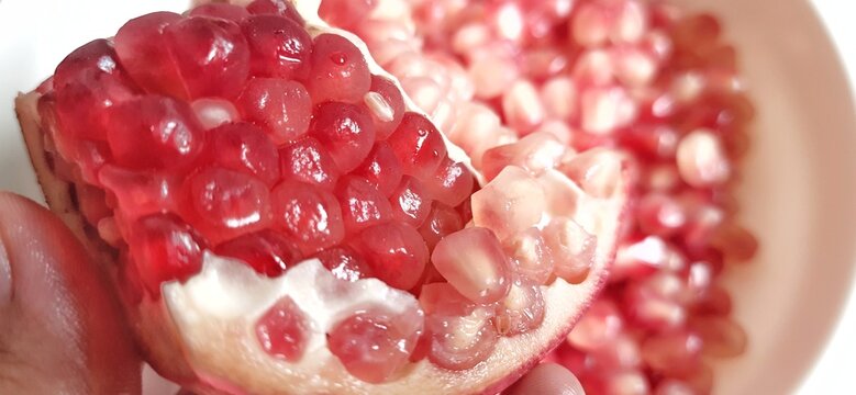 Delicious sweet Pomegranate seeds or buah delima background