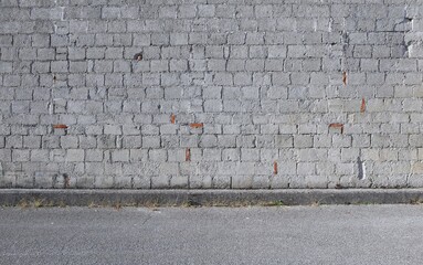 Grunge cinder block wall with bricks inserted. Background for copy space.