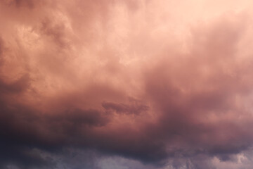 Fototapeta premium Dramatic storm clouds in the summer sunset. Dark, heavy, dramatic and colorful summer storm clouds, background, texture 