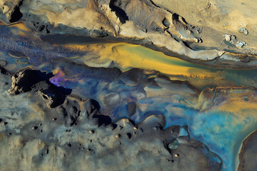 Fototapeta premium Aerial view of the surreal, colorful patterns on Iceland's glacial rivers and lakes, The scene showcases intricate