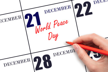 December 21. Hand writing text World Peace Day on calendar date. Save the date.