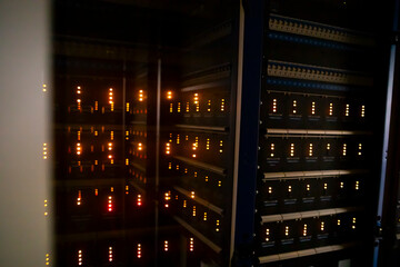 Dark server room with LED lights.  Central computer technology room of a small business.