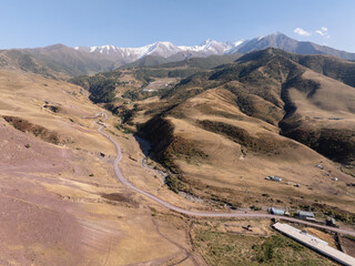 View of autumn landcape with mountains and hills. Yellow fields on the hills. Road in the hills....
